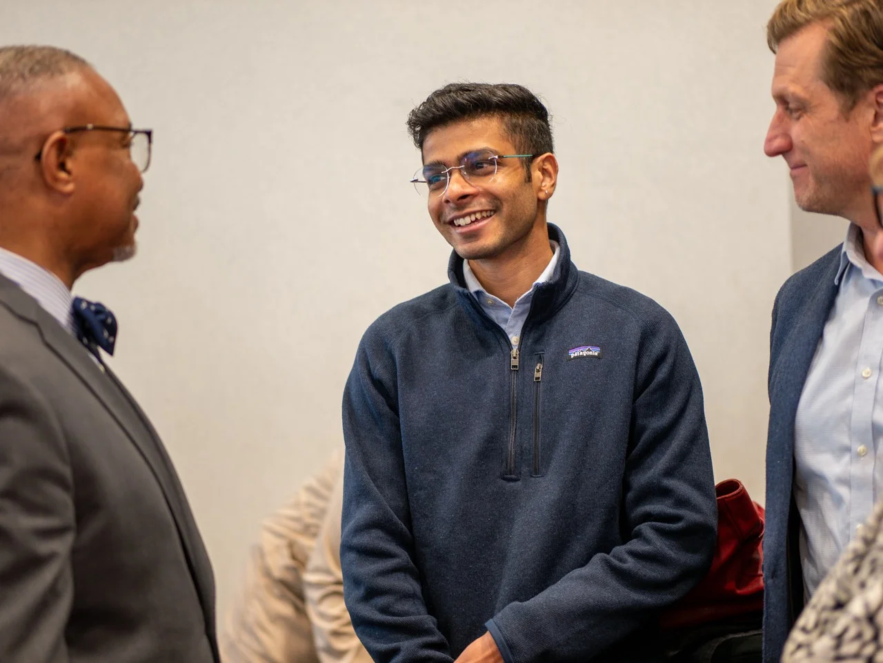 Candid Photograph of Siddhartha Bariker talking to someone in a conference.